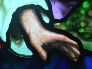 Close-up of Jesus' hand portrayed in Rainbow's stained glass window.
